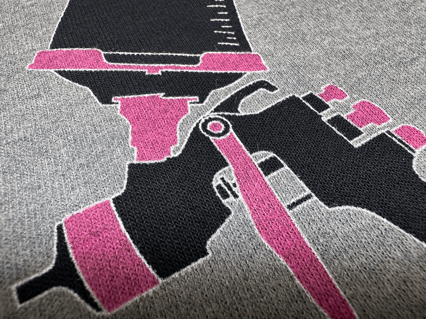 Pink and Black PSA Logo on Black Hoodie Close Up Tilted Up and Left Angle View of Paint Gun