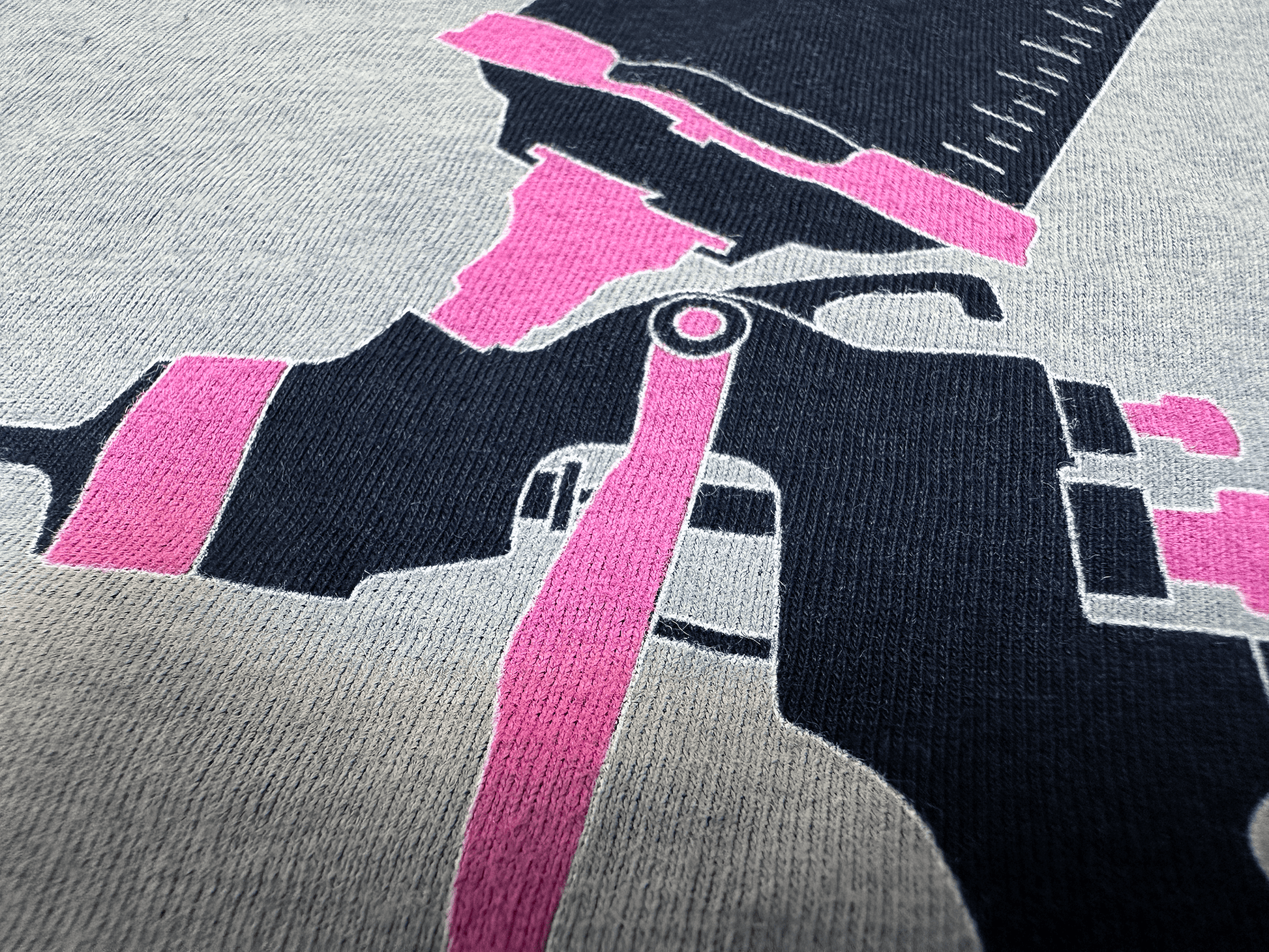 Pink and Black PSA Logo on Ladies' Black T-Shirt Close Up Tilted Up and Right Angle View of Paint Gun